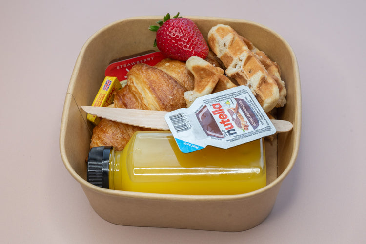 Individual brunch box with croissant, waffle, Nutella, and orange juice – breakfast catering delivery Manchester