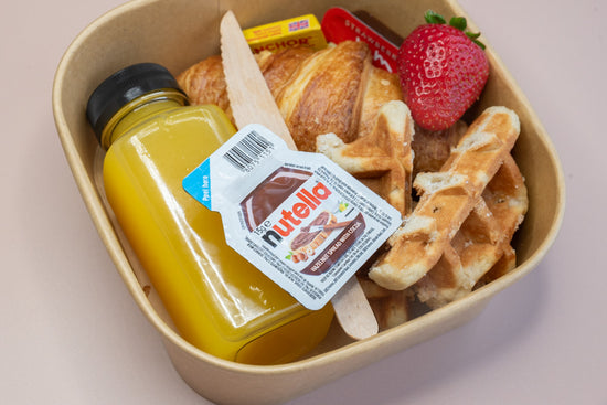 Individual brunch box with croissant, waffle, Nutella, and orange juice – breakfast catering delivery Manchester