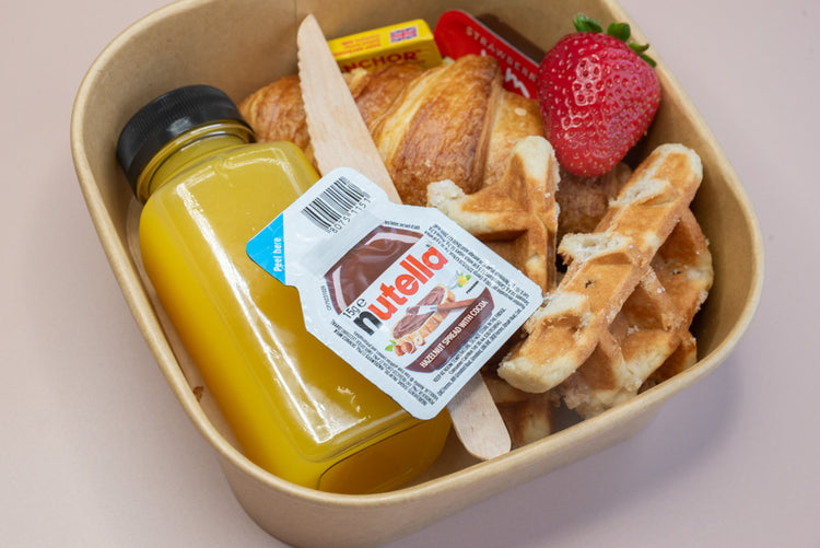 Individual brunch box with croissant, waffle, Nutella, and orange juice – breakfast catering delivery Manchester