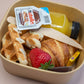 Individual brunch box with croissant, waffle, Nutella, and orange juice – breakfast catering delivery Manchester
